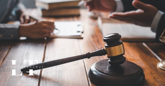 lawyer helping client at table