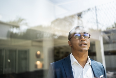 businessman looking out his shop